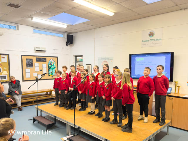 a school choir sing in the school hall