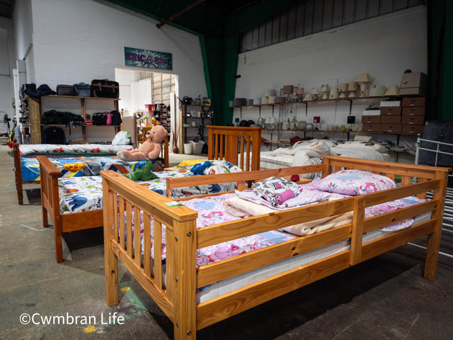 several wooden beds in a warehouse