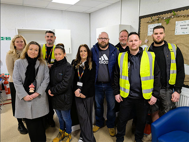 group of men and women stood in a new kitchen