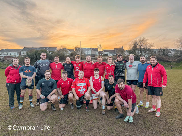 a men's rugby team have a team photo after training