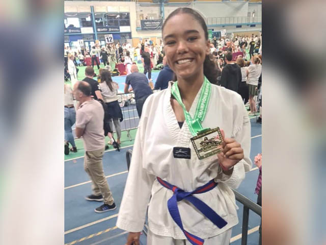 Grace Adam holding a gold medal
