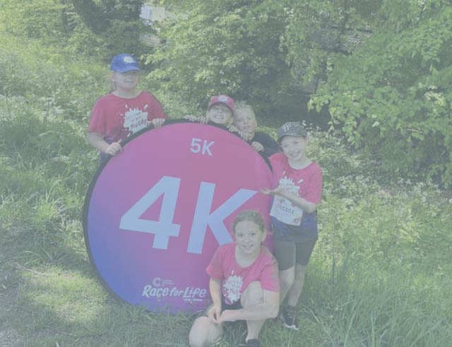Mila, Mollie, Lois, Gerry and Sienna stood by a 4k sign