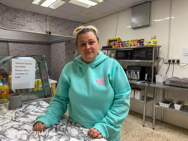 a woman behind the counter of a cafe