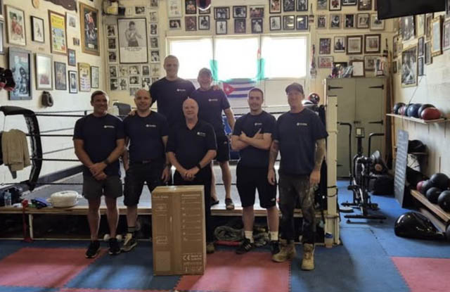 Staff from Plumbob inside Pontypool Boxing Club by the ring