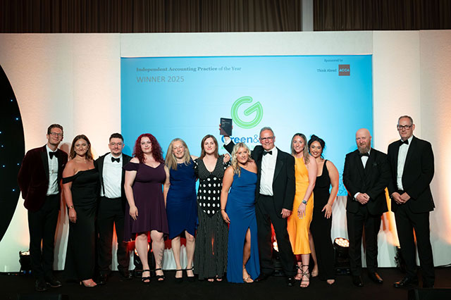 a team of accountants on stage collect an award