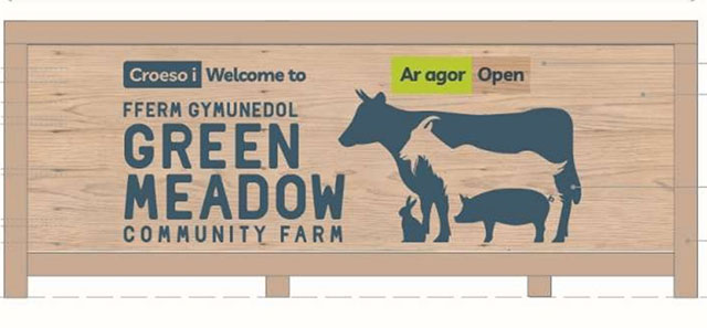 a logo on a wooden sign of farm animals