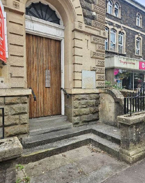 the doorway of a former bank