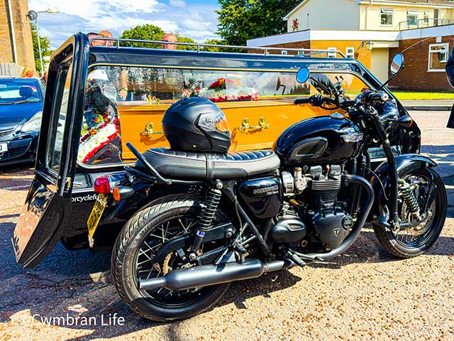 a hearse next to a side