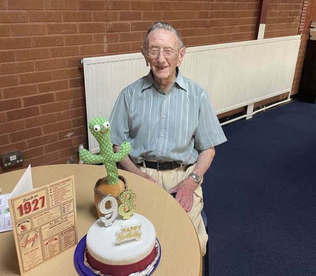 a man with his 98th birthday cake