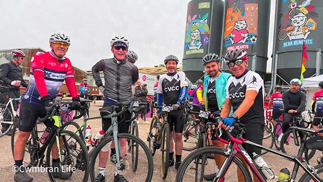 five cyclists smile for the camera before a race