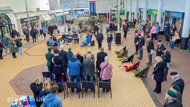 a brass band, veterans, flag bearers at a poppy appeal launch