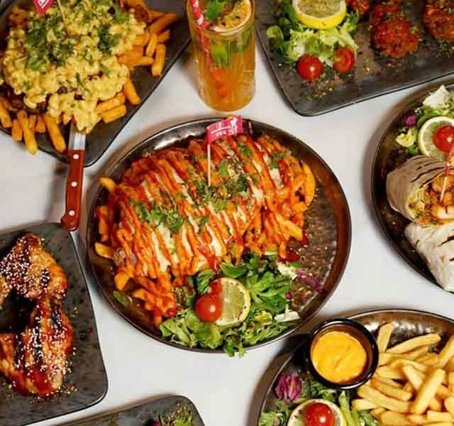 a selection of plates with food including chicked and chips covering them