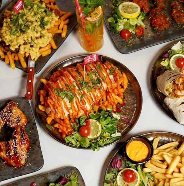 a selection of plates with food including chicked and chips covering them