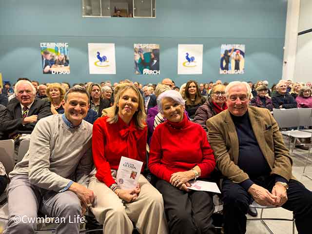 two men and two women sat in the front row of a concert