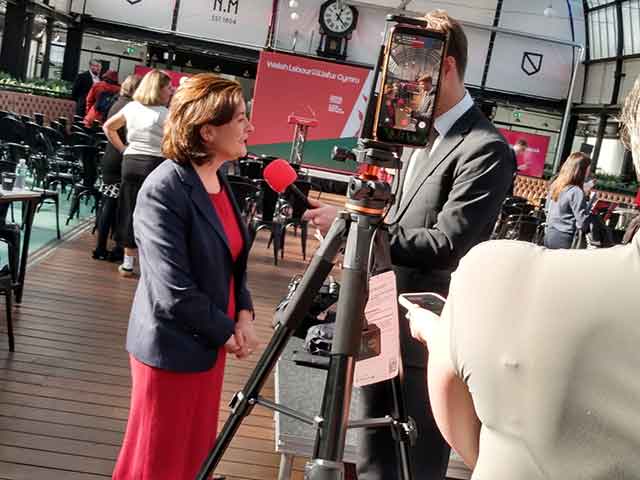 a woman being interviewed by a journalist