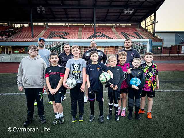 a football team and their coaches on pitch