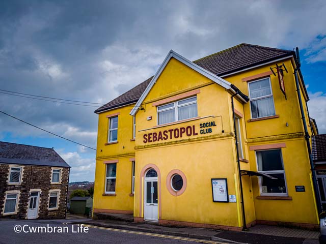 a large yellow painted building with Sebastopol Social Club on it