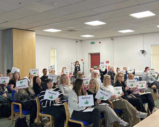 a roomful of people sat in chairs