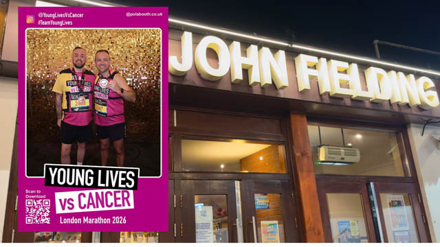 two men holding medals and wearing running kit