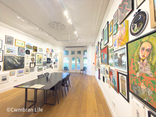 a gallery with art covering the walls