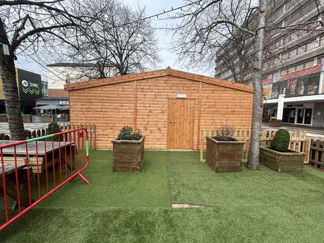 a wooden building in a town centre
