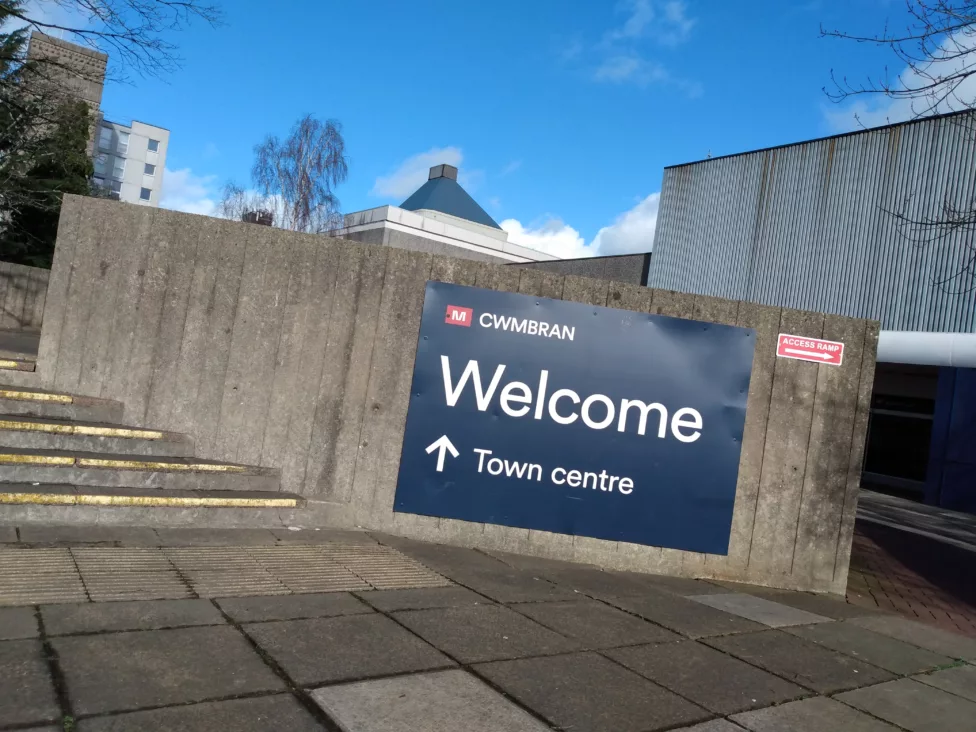 a sign on a wall saying Welcome, town centre