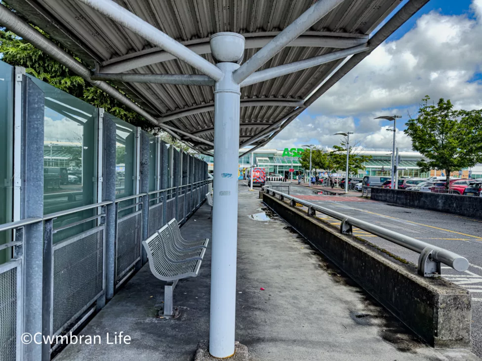 a bus stop near an asda supermarket