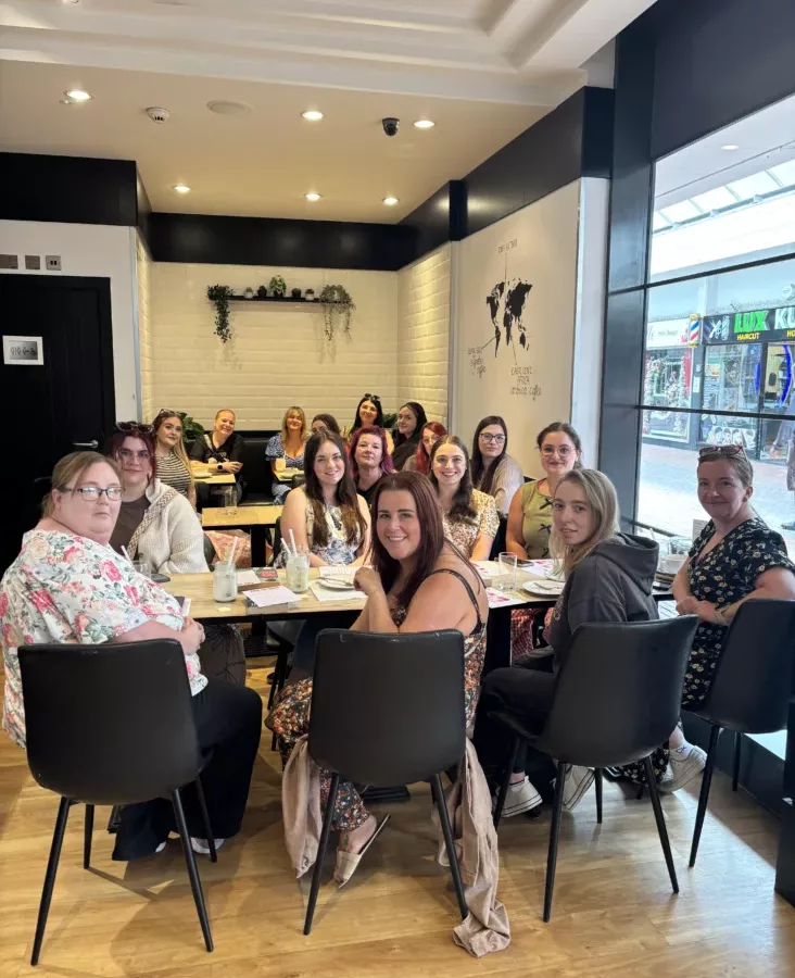 a group of people in a coffee shop sat at tables