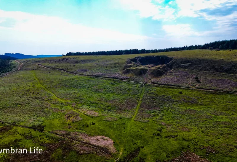 a hillside with a quarry dug into it