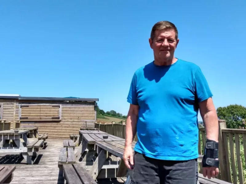 a man stood by some decking