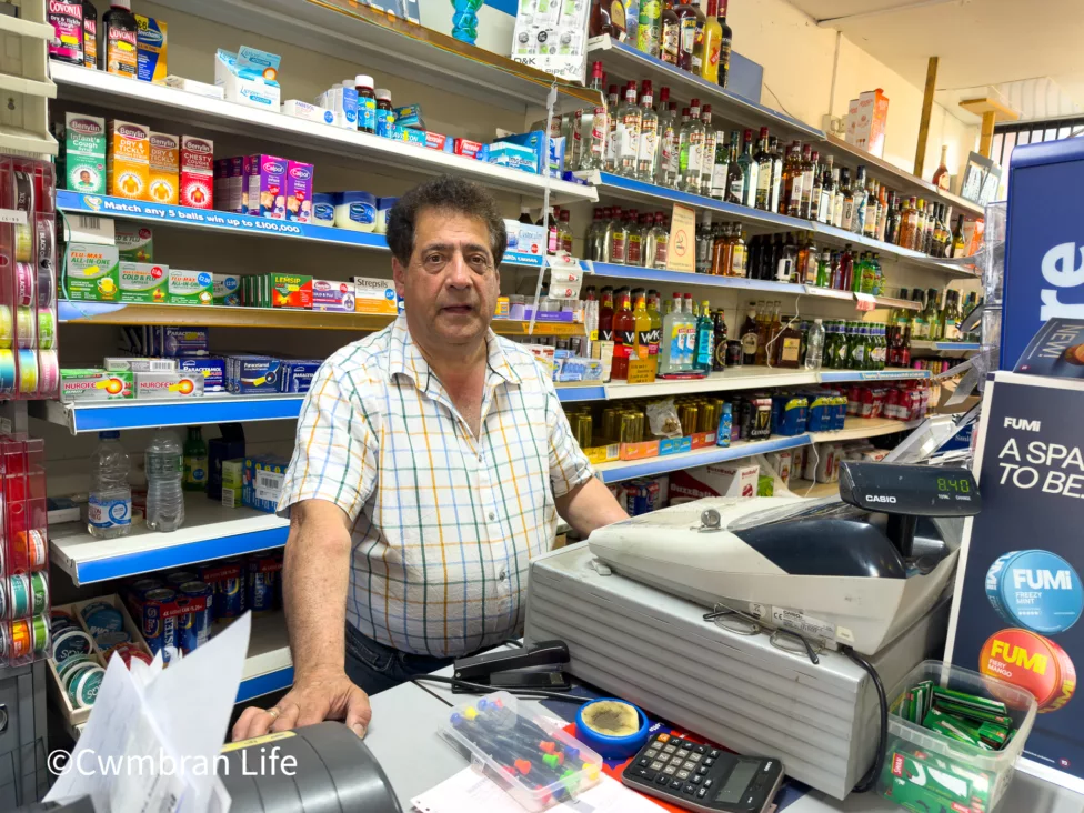 a man behind a shop till