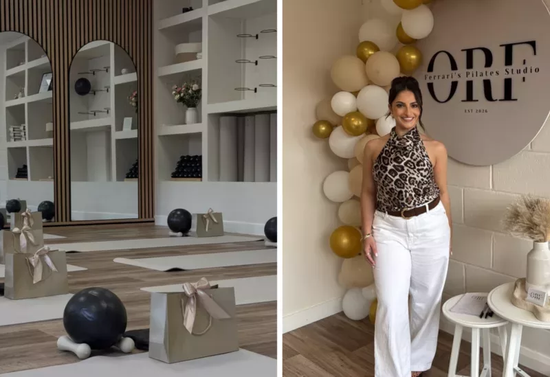 a photo of a pilates studio with mats on the floor and a women stood holding a drink
