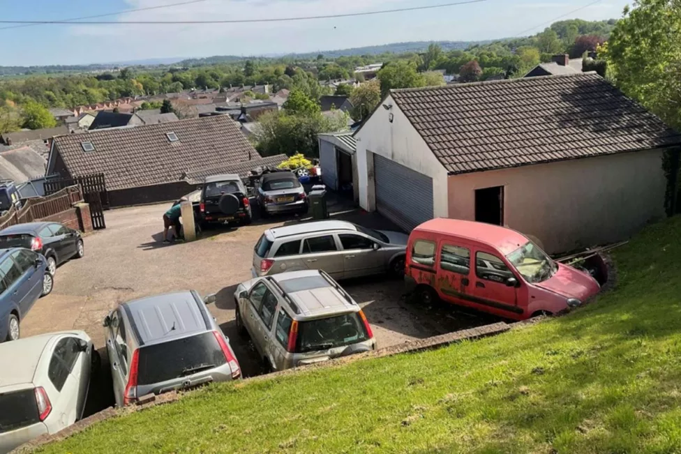 a photo of cars parked outside a garage