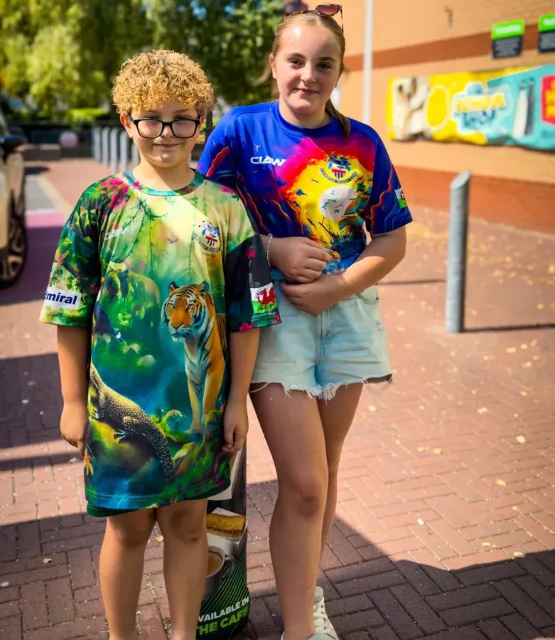 a brother and sister, aged 8 and 13, stood next to each other