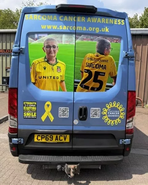 a van with a link to the sarcoma cancer website and images of a woman wearing a wrexham fc shirt