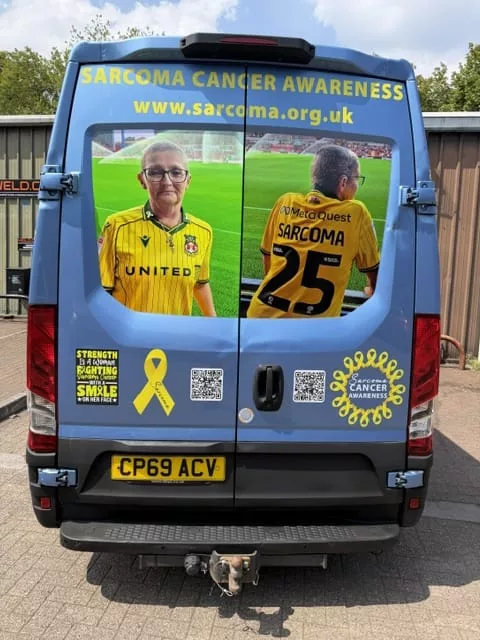 a van with a link to the sarcoma cancer website and images of a woman wearing a wrexham fc shirt