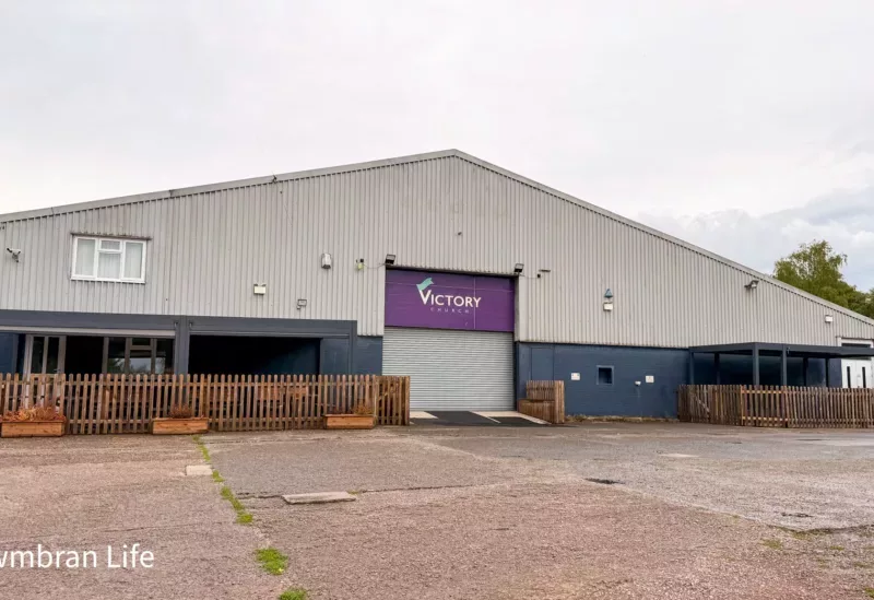 a large industrial unit ith a sign saying victory church above the door