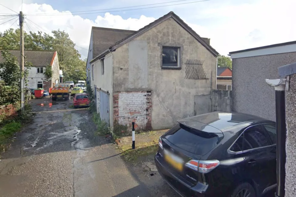 an old house with a car parked outside