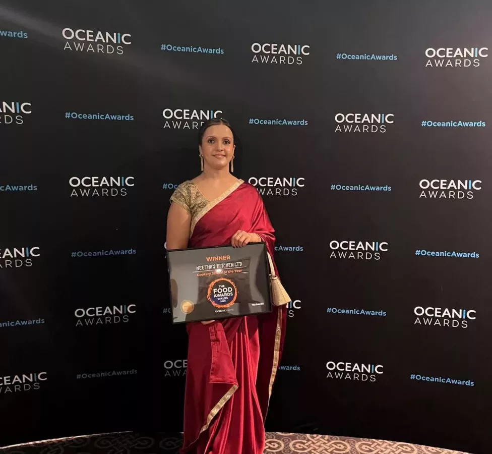 a woman holding a certificate for an award