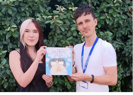 a man and woman holding a book