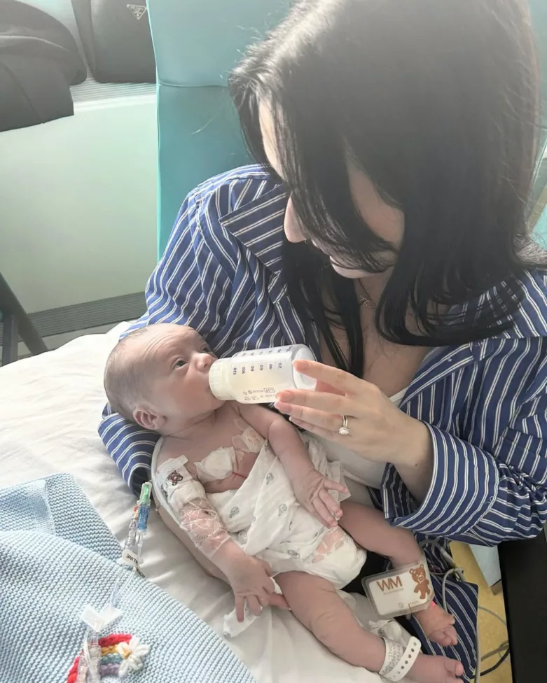 a woman feeding a baby with a bottle